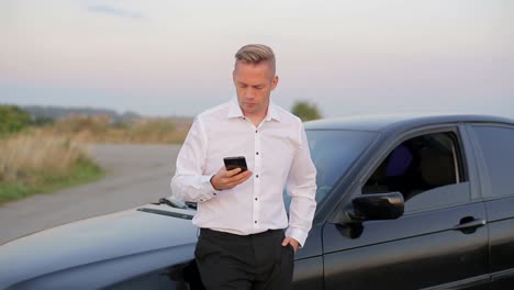 businessman with the problem of checking the car under the hood businessman with the problem of checking the car under the hood car crash