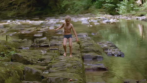 boy playing in a river