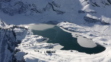 aerial view of a frozen alpine lake in the swiss alps