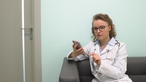 pretty female doctor having a phone call at clinic