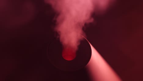working a humidifier with a red circular light in the middle