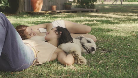 Females-Lying-With-A-Big-Dog-On-The-Grass