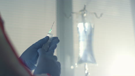 nurse holding syringe vaccine close up. hospital infectious disease department