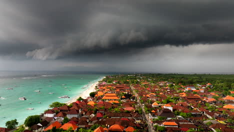 incredible color contrast between stormy black clouds over turquoise ocean water of nusa lembongan in indonesia