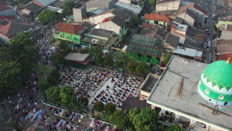 aerial view of people offering prayers on the eid morning at famous mosque jama masjid in bekasi