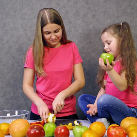 mother with daughter making salad