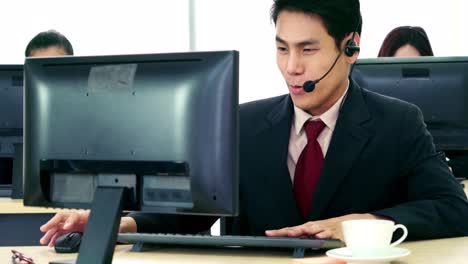 Business-people-wearing-headset-working-in-office