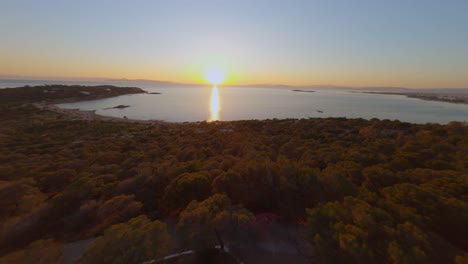 FPV---Flying-towards-Kavouri-Beach-in-Vouliagmeni,-Greece-at-sunset