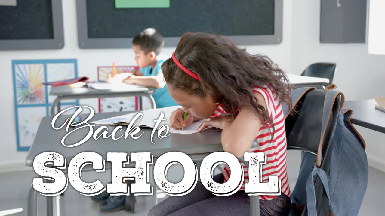 Animation of back to school text over diverse schoolchildren writing in classroom