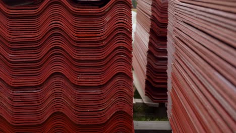 stacked red corrugated roofing materials