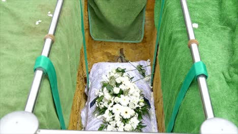 closeup shot of a funeral casket in a hearse or chapel or burial at cemetery