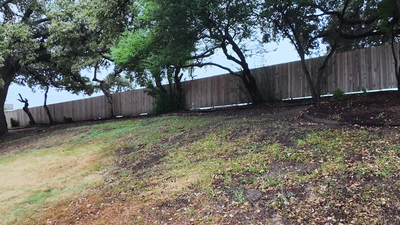 View of grassy knoll fence with slow camera pan left