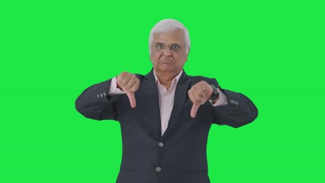 Angry-Indian-senior-manager-showing-thumbs-down-Green-screen