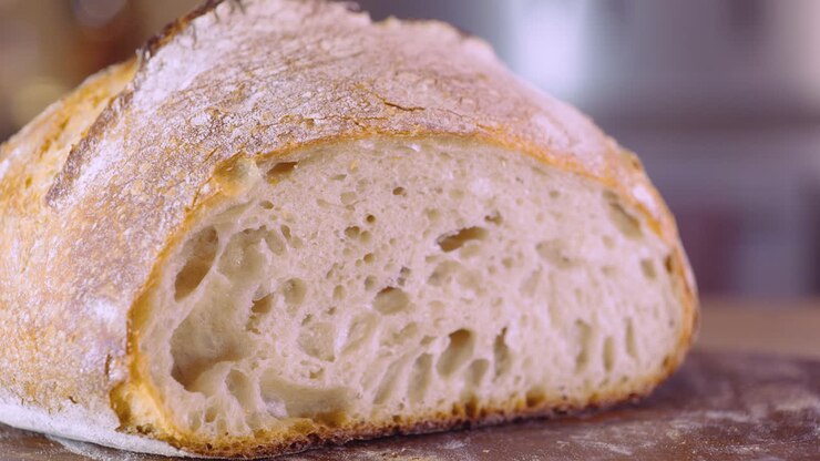 Sourdough Bread Loaf On Cutting Board - macro, pan shot
