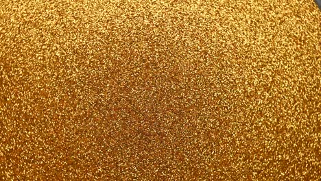 golden glitter background with sparkling texture. moving fast in a circle