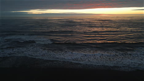 Establishing-Aerial-Drone-Shot-Over-Sea-at-Stunning-Sunrise-in-North-Yorkshire-at-Low-Tide-UK