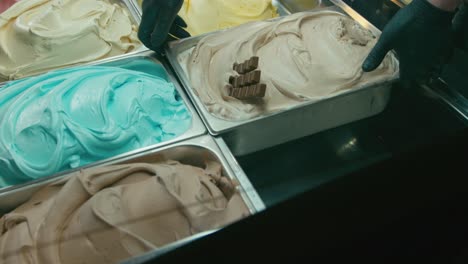 putting a chocolate gelato ice cream tray in a showcase