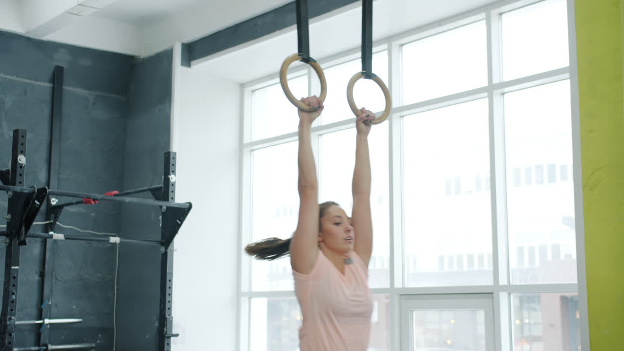 Woman performing exercises with gym rings