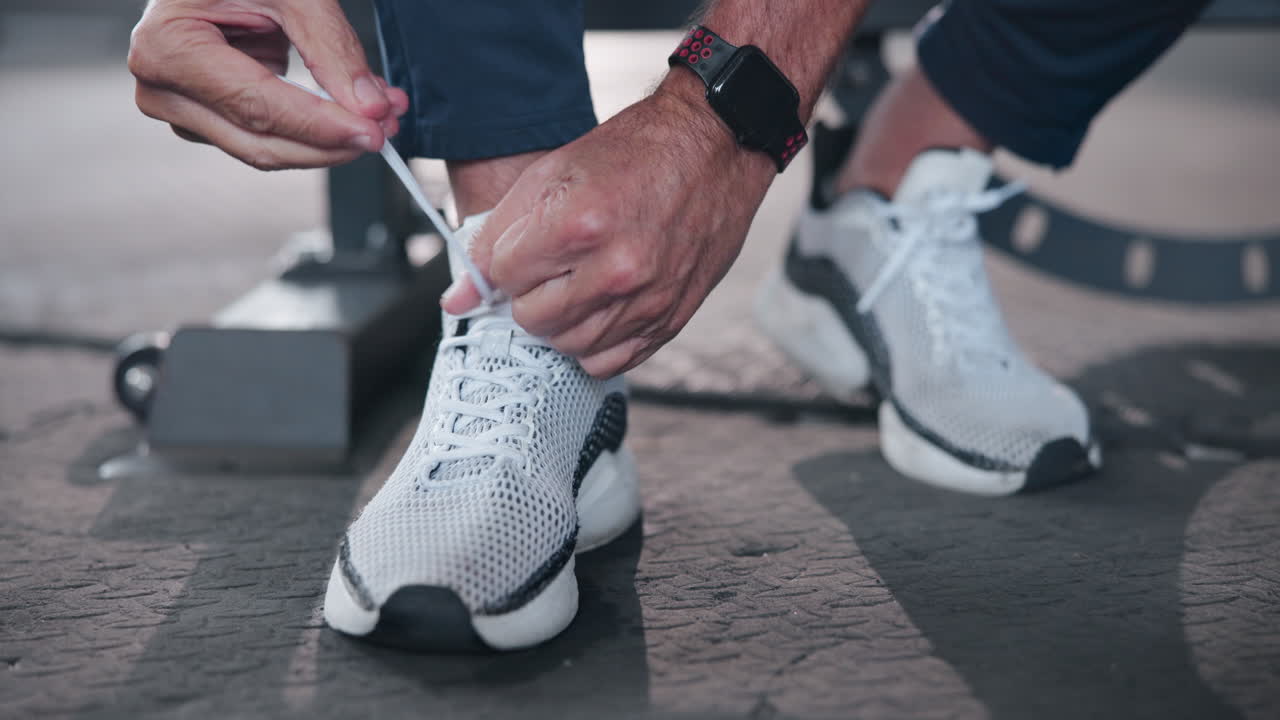 Close up of person tying shoelaces on sneakers