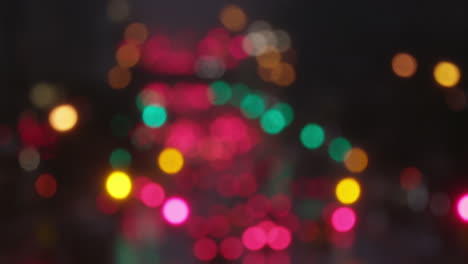 Slow-mo-of-a-wet-New-York-Manhattan-main-street-at-night-with-traffic,-in-winter-with-snow