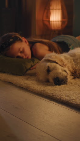 girl and dog sleeping together at home