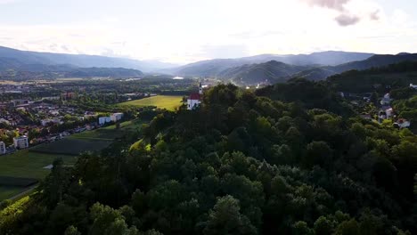 a church on top of a hill in the mountain next to city