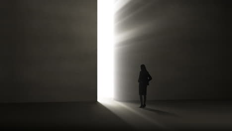 businesswoman looking at light shining through opening