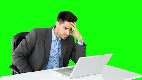 Handsome-businessman-working-at-desk