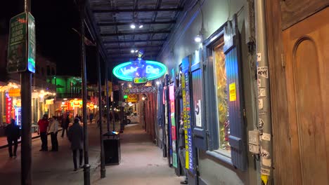 tilt down to  an establishing shot of bourbon street in new orleans at night