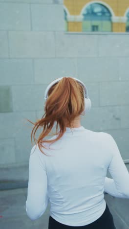 a young woman in athletic wear enjoys her jogging routine while listening to music, embracing a healthy lifestyle with focus and energy