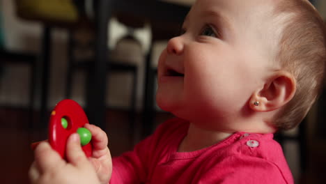 Close-up-shot-of-cute-little-baby-smiles-and-plays,-shot-in-slow-mmotion