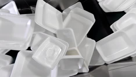 used foam boxes undergo a cleaning process and are then moving along a conveyor belt.