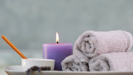 beauty treatment in bowl presented on plate with candle