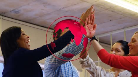 animation of spinning globe over diverse colleagues high fiving each other at office