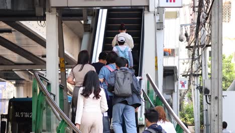 people climbing stairs in a busy city setting