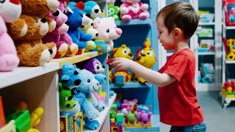 young boy playing with a toy car in a vibrant toy store