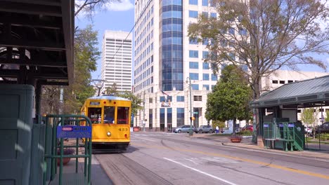 memphis trolley car on a busy street outside downtown business district office buildings