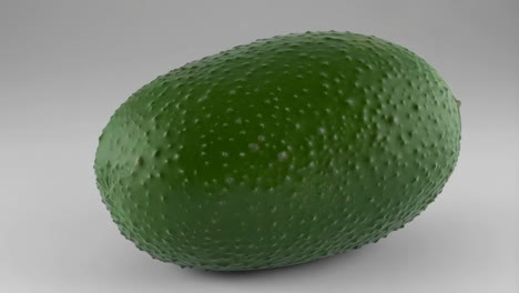 green avocado on a plain background