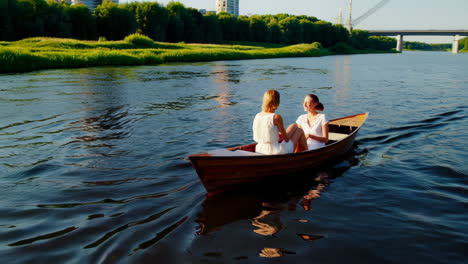 two women enjoying a boat ride on a sunny day