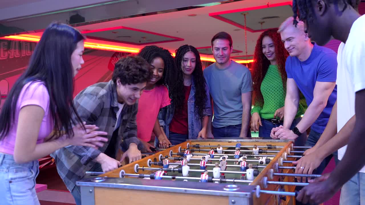 People having fun playing table football