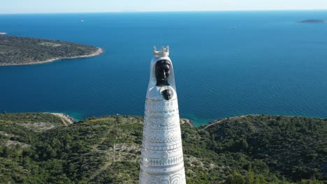 scenic view of our lady of loreto statue in primosten, croatia at daytime - aerial drone shot