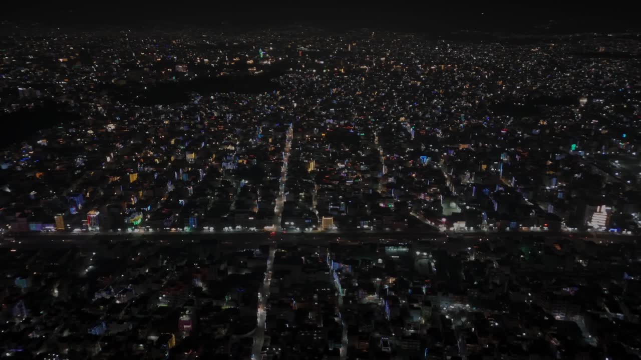 Aerial night footage of Kathmandu city during Diwali (Tihar), featuring the illuminated Dharahara Tower and glowing skyline filled with festive lights, showing Nepal’s vibrant cultural celebration