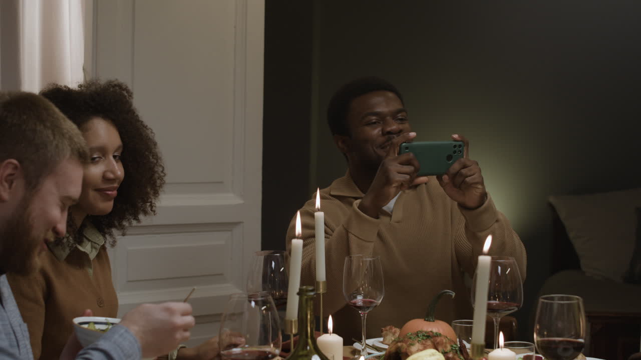 Friends gathering at dinner taking pictures