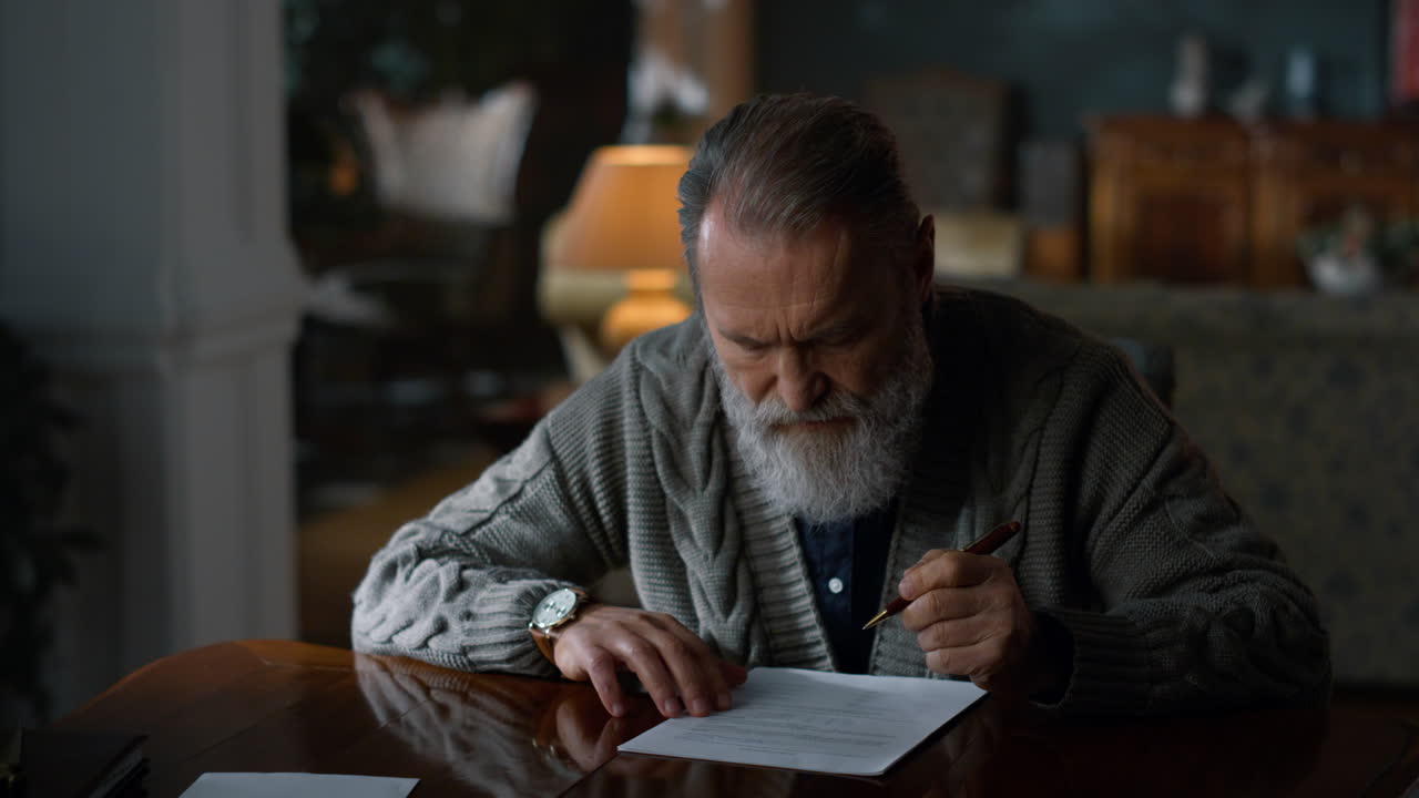 Focused gentleman working on documents indoors