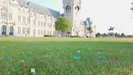 the palace of culture in iasi with a green lawn and scattered confetti