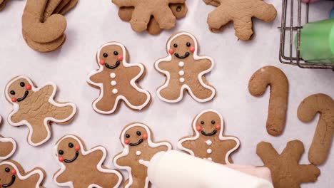 decorating gingerbread cookies with royal icing for christmas.