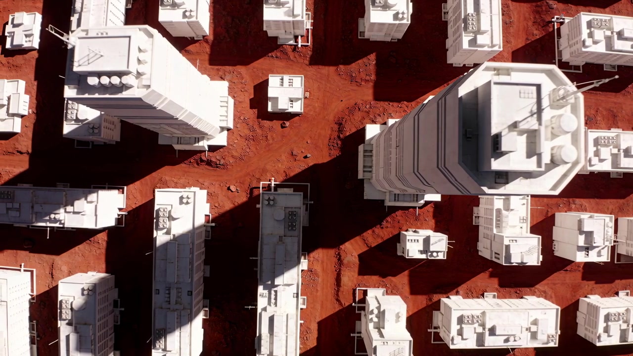 Panning drone scanning white midrise cluster from overhead, revealing rooftop tanks for inspection