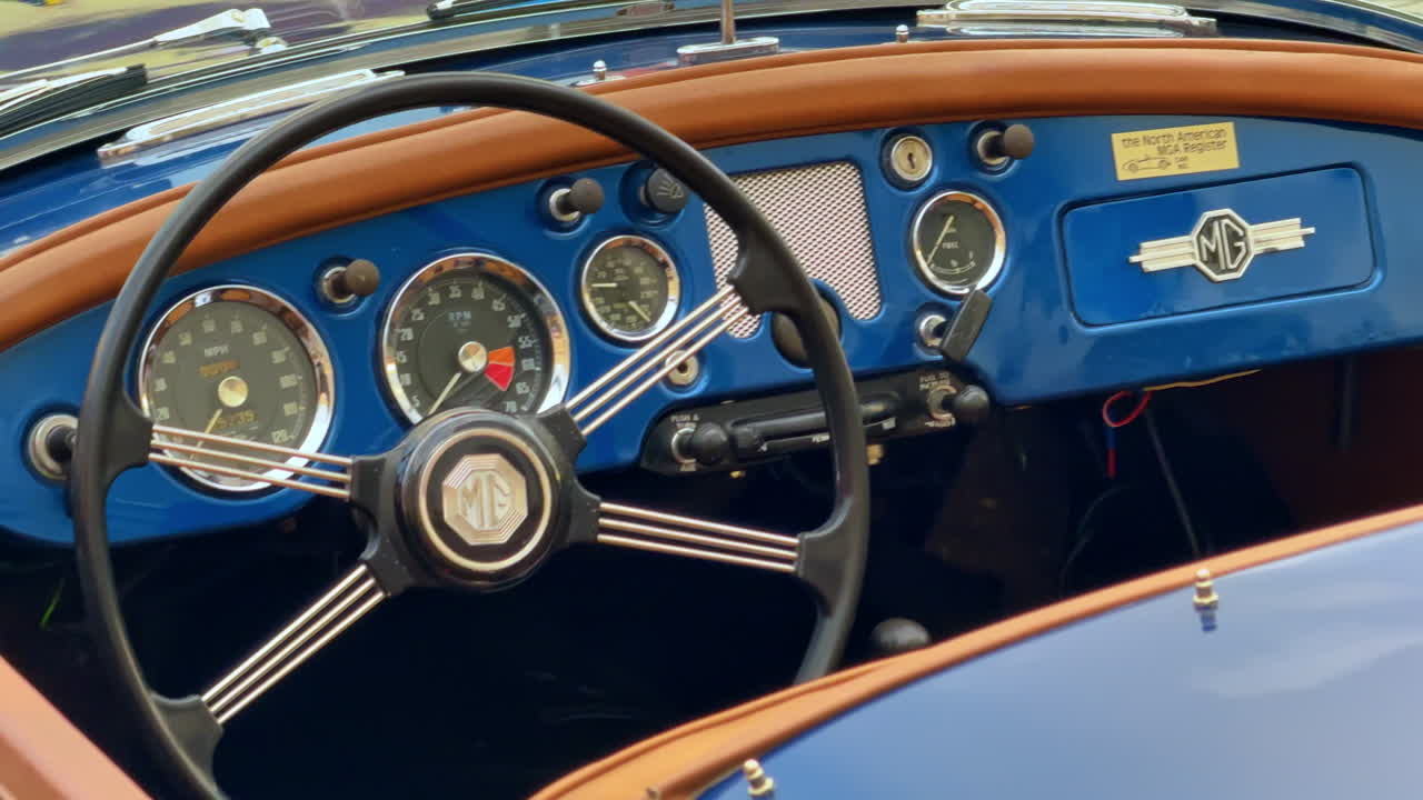 Sibiu, Romania, 17 July 2025: Vintage MG dashboard close-up. Detailed view of a retro MG steering wheel and gauges during exhibition in Sibiu, Romania
