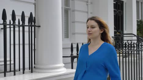 Confident-young-woman-walking-down-street