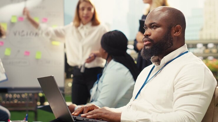 Professional Man Working on Laptop During Office Meeting